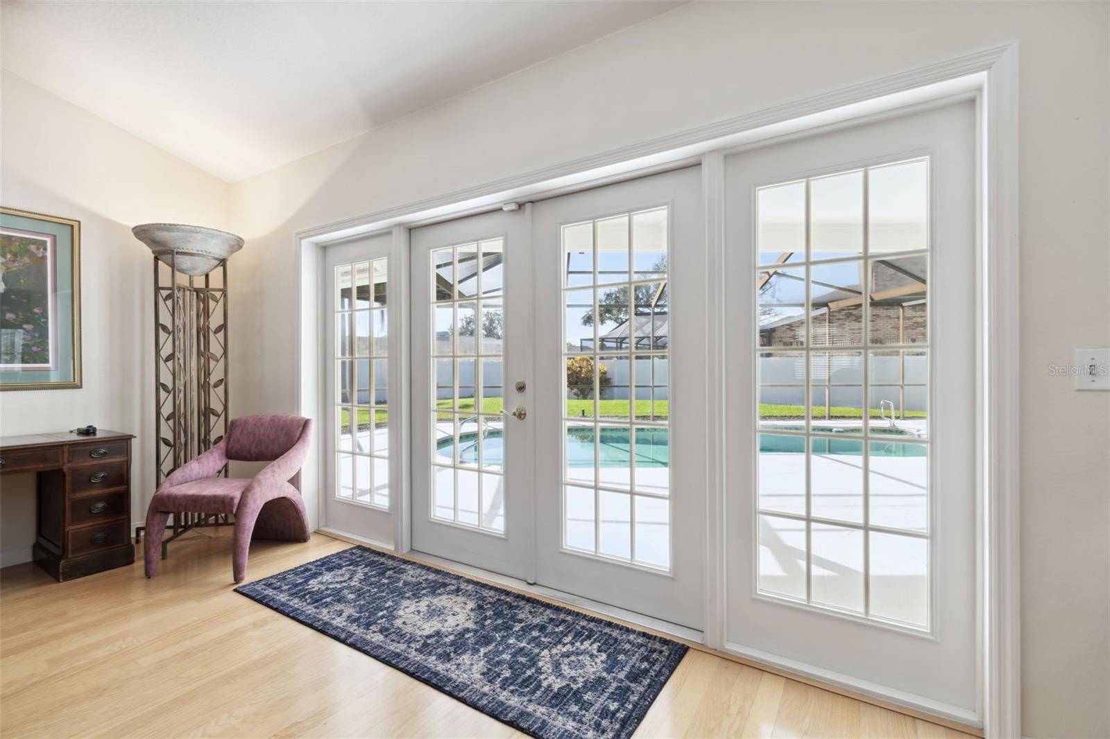 All french doors lead to the screen enclosed pool area.