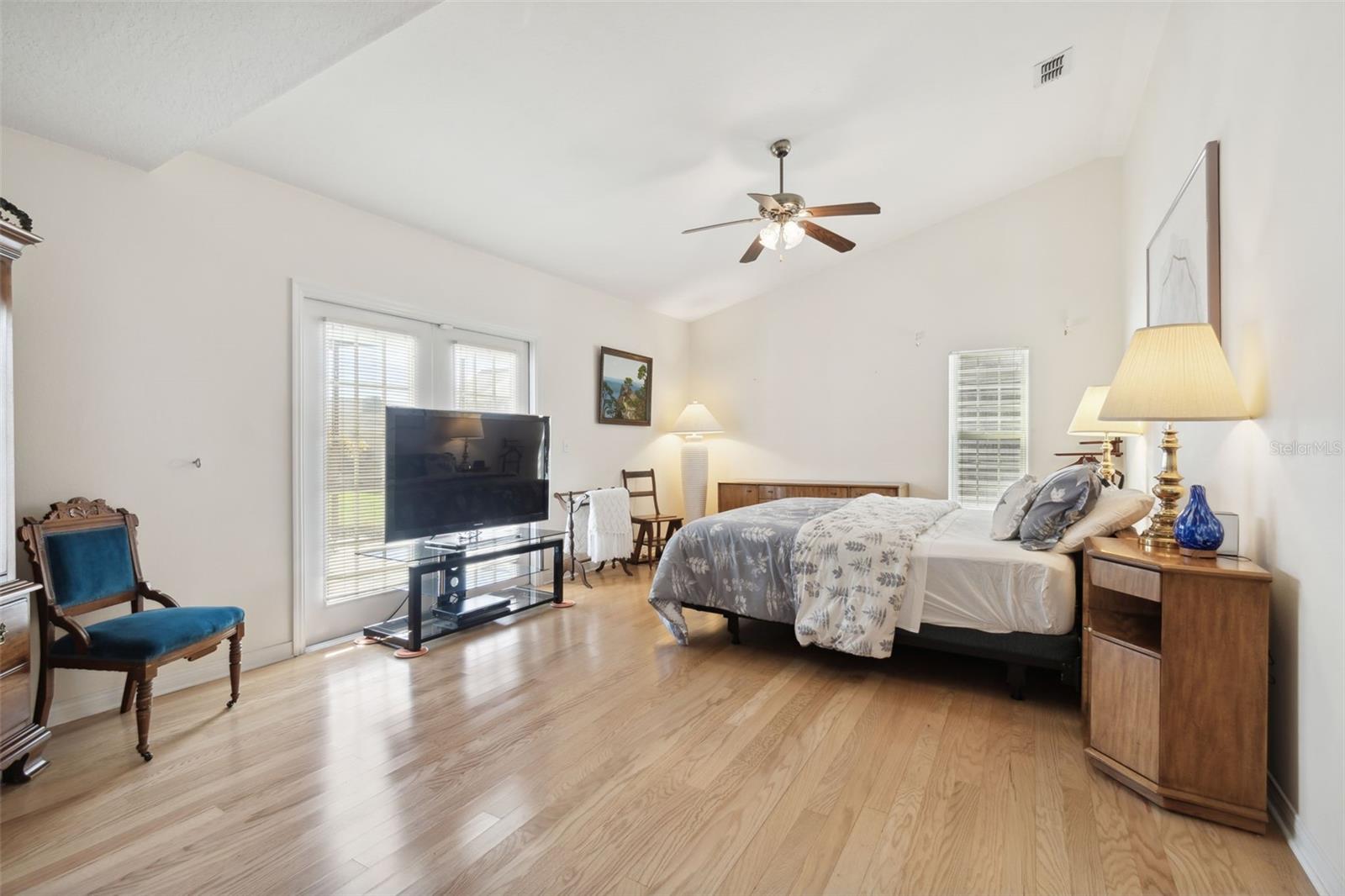 Master bedroom with beautiful view of the pool area.