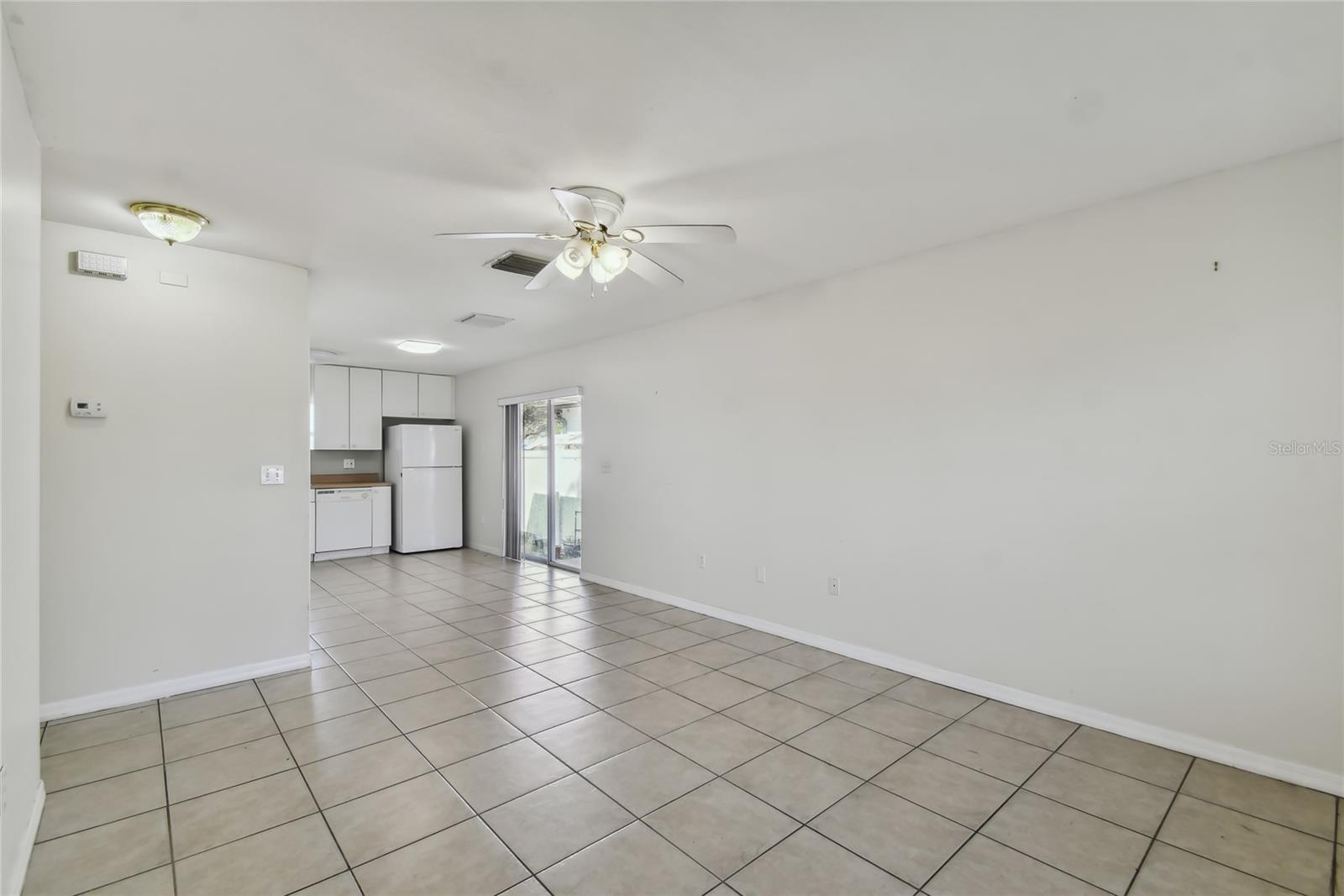 Front door view of living room and partial kitchen view