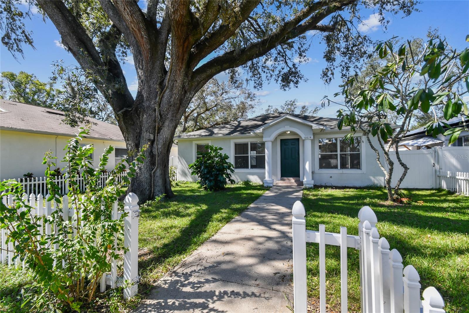 Front entrance with view of garden and fence