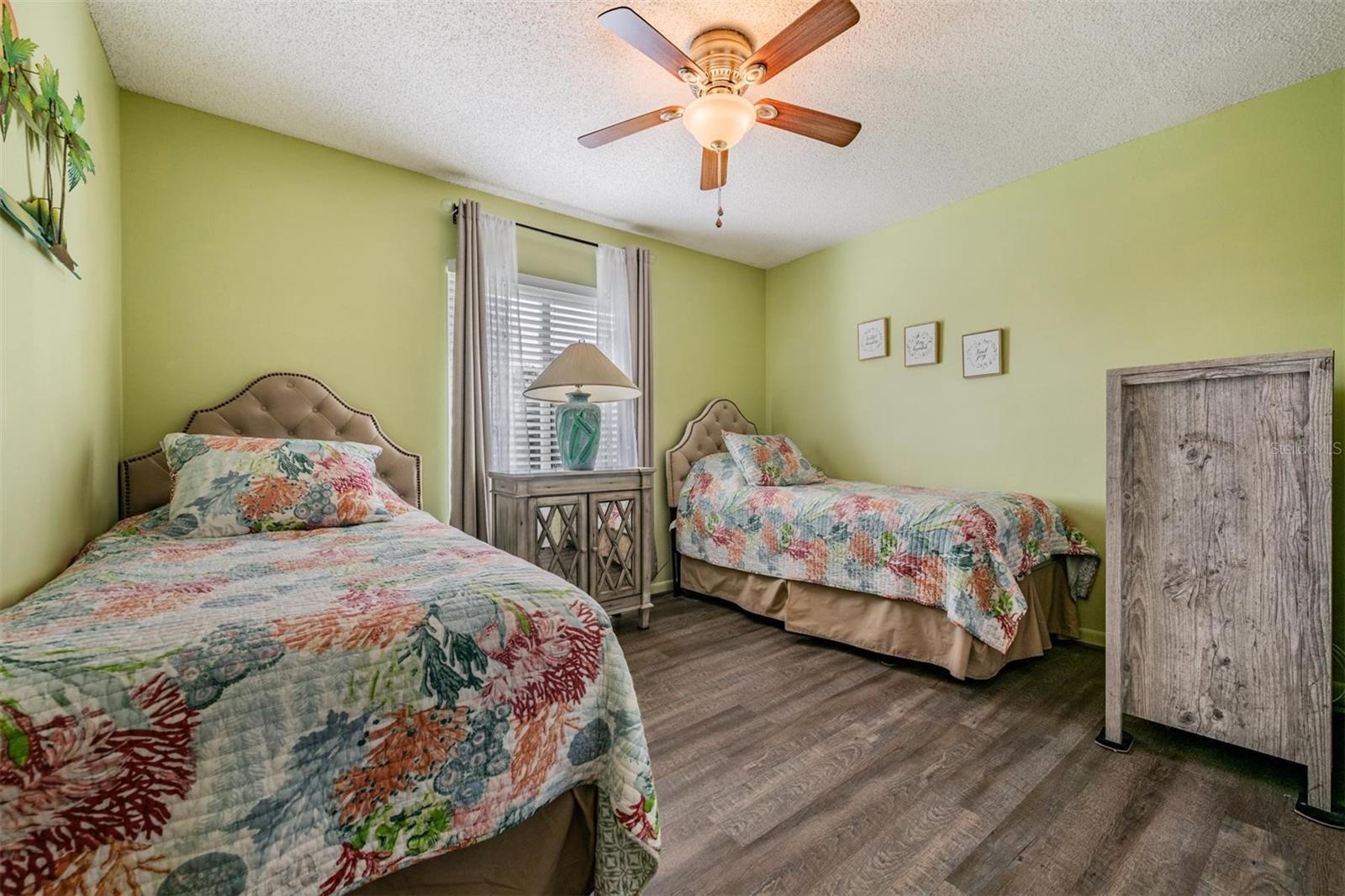 The second bedroom comes with twin beds and a convenient wall closet, ideal for guests or a home office.