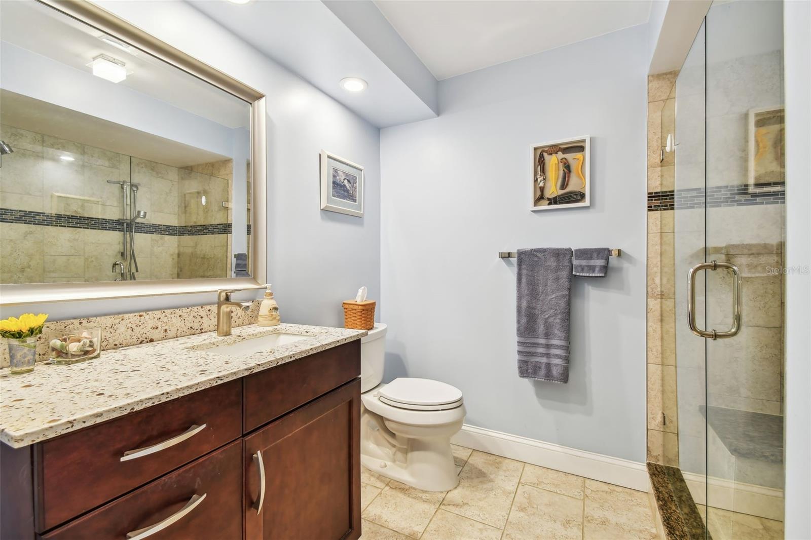 Primary bathroom with glass shower doors.