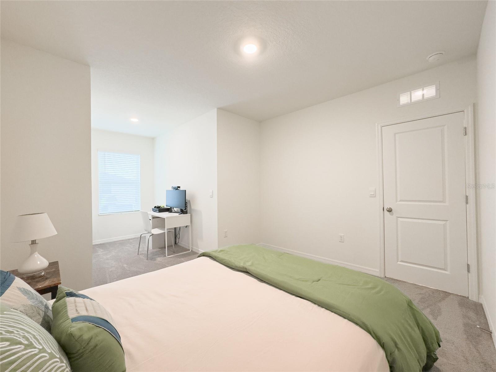 This guest bedroom blends coziness with modern flair - perfect for unwinding after a day of paddleboarding at the nearby lagoon. Bonus points for the spacious closet and a sweet nook for your morning coffee or a little home office action!