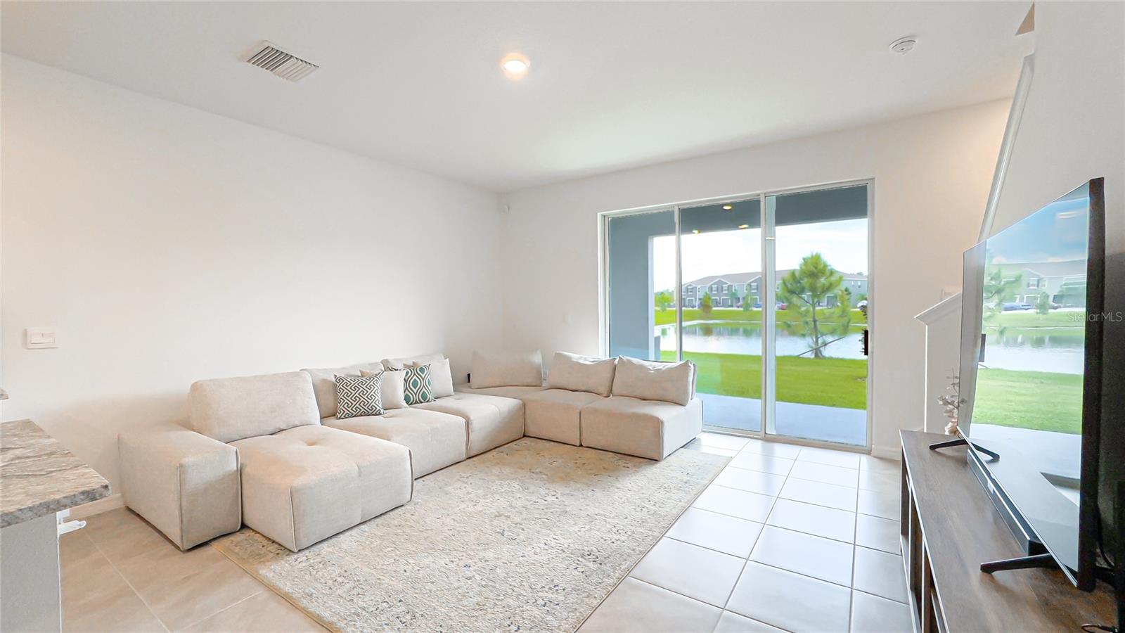 Kick back and relax in this sun-soaked living room with stunning pond views! Whether you’re hosting movie night or lounging with a book, you've found your happy place. And with high school, grocery stores, and a dog park nearby, convenience is just a stroll away!