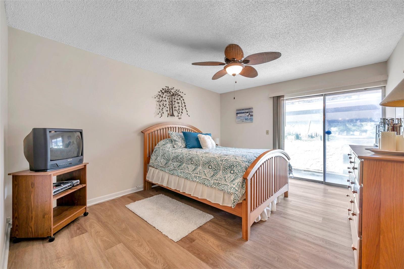 Master bedroom with master bedroom has sliding glass door to patio