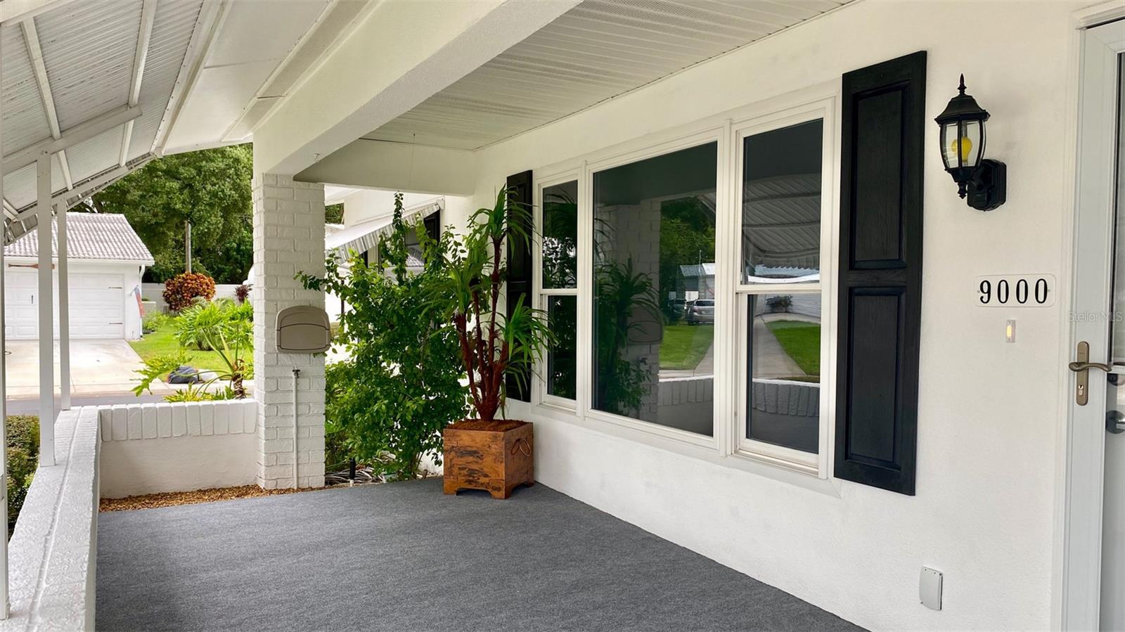 Picture yourself enjoying your favorite beverages on this shaded porch.