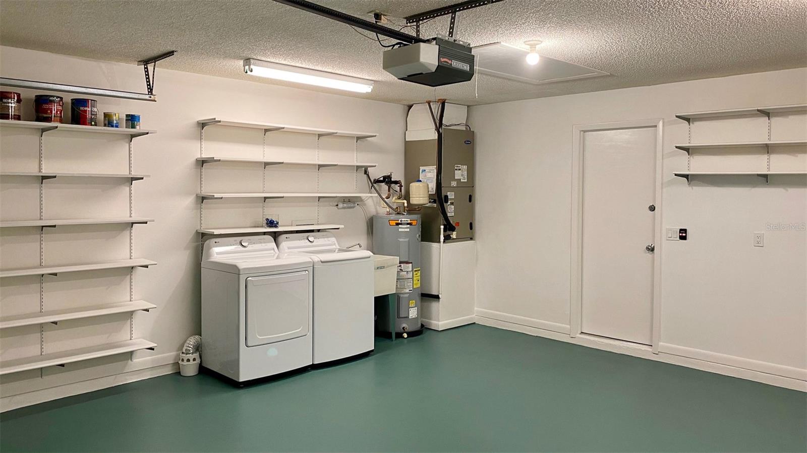 The garage has storage shelving and space galore!