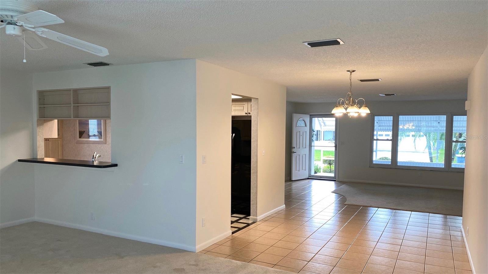 the view from the Family room up to the porch. The kitchen passthrough is ideal when entertaining. Notice the creative shelves in that passthrough to show off your treasures.