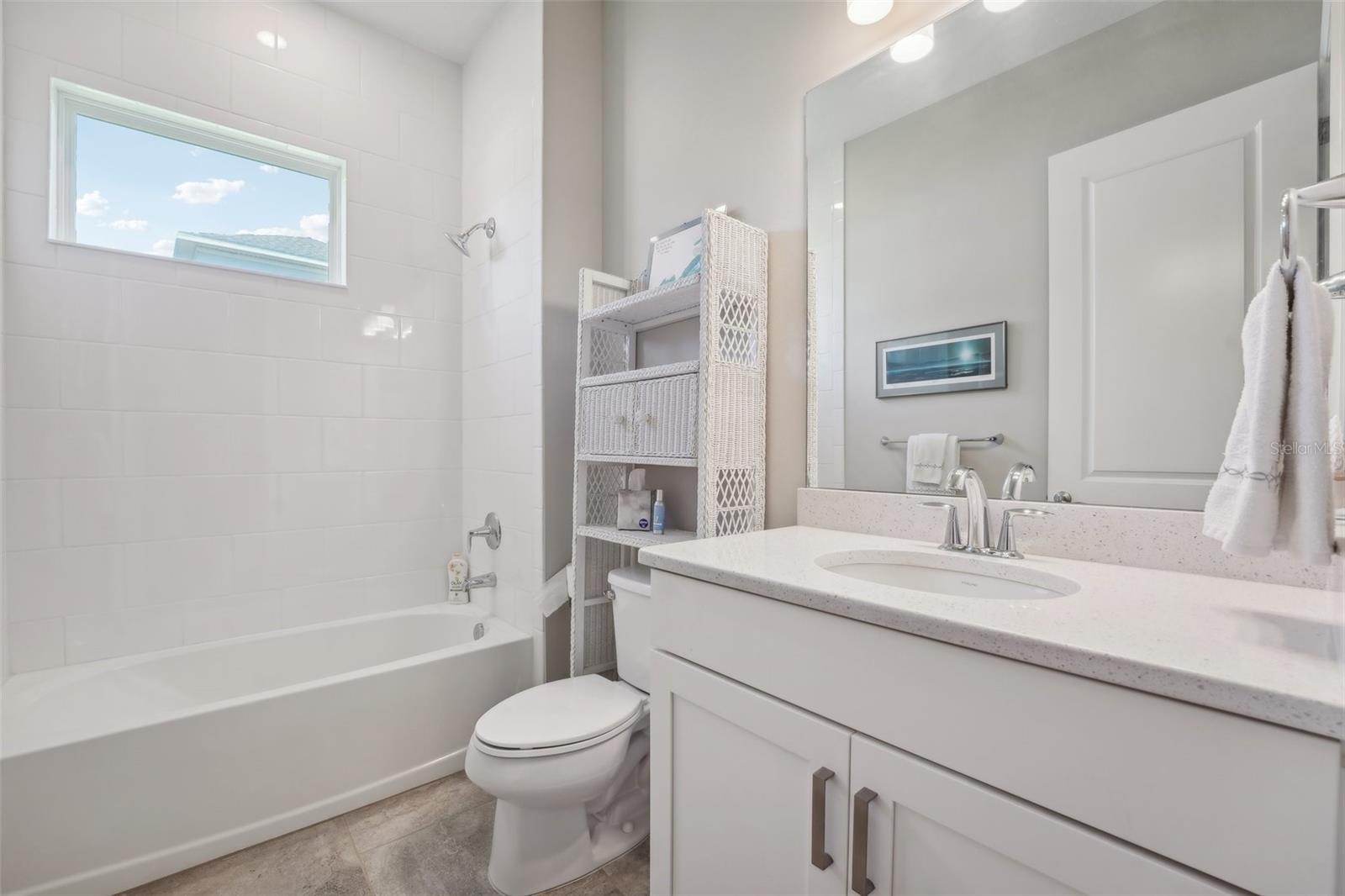 Guest bathroom with tile to the 10' ceiling