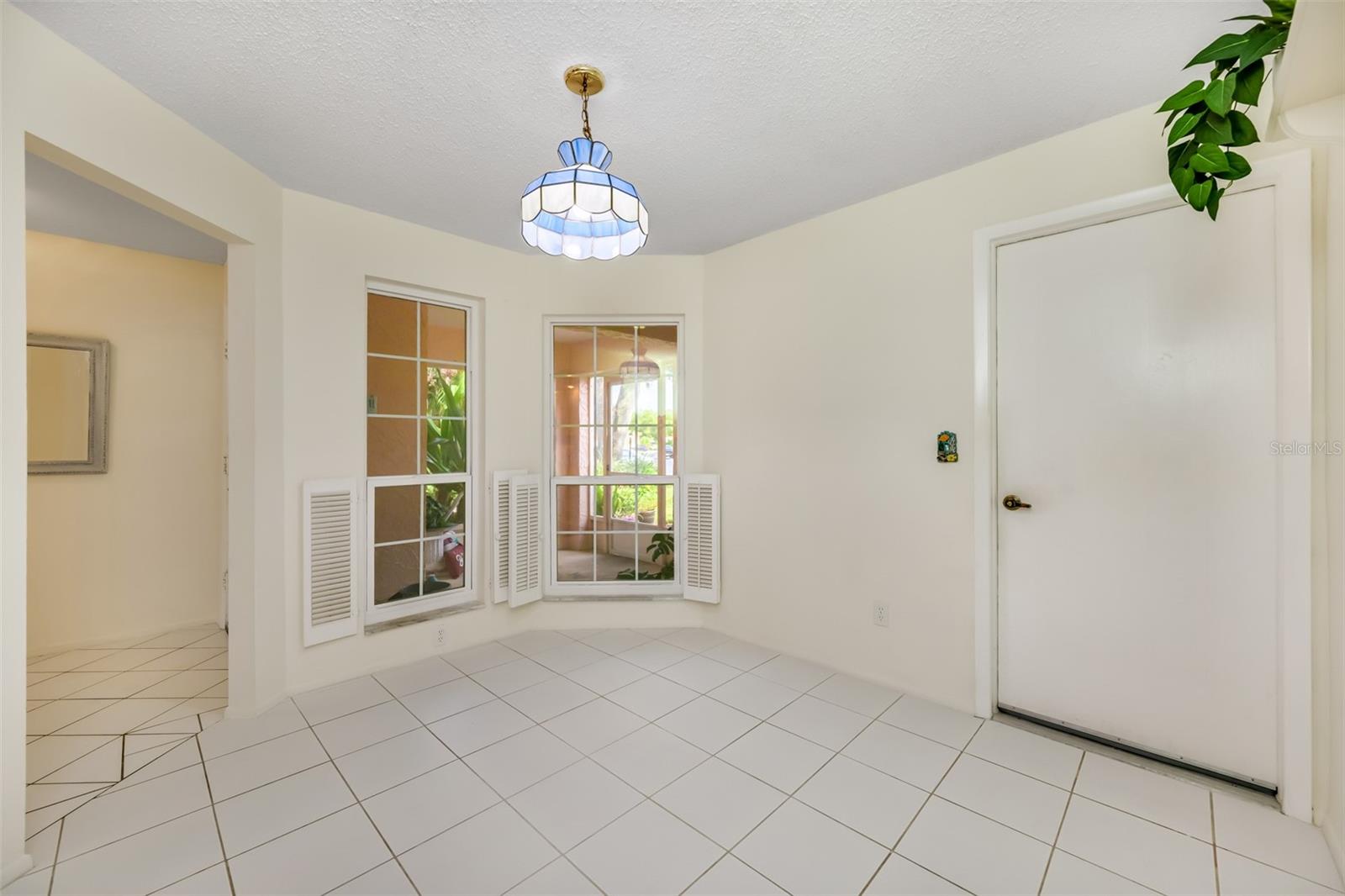 Kitchen nook has a nice view outside the front screen porch and also leads out to the ATTACHED garage.