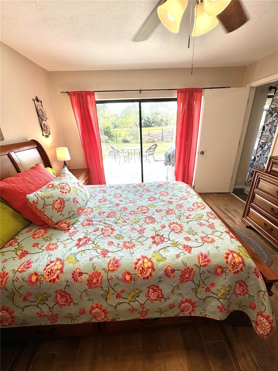 Sliding doors give access to the back yard from the primary bedroom