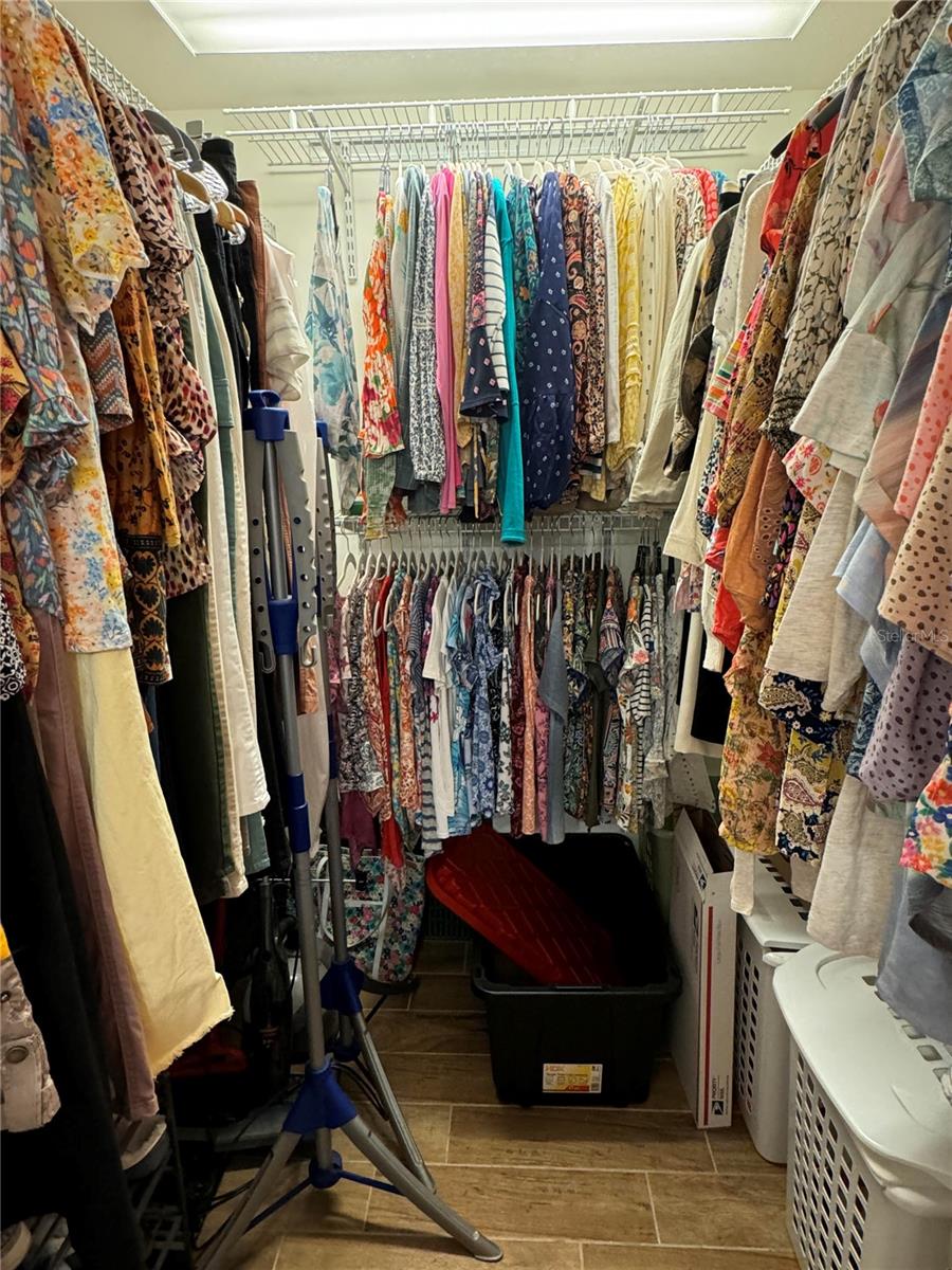 Primary bedroom walk-in closet