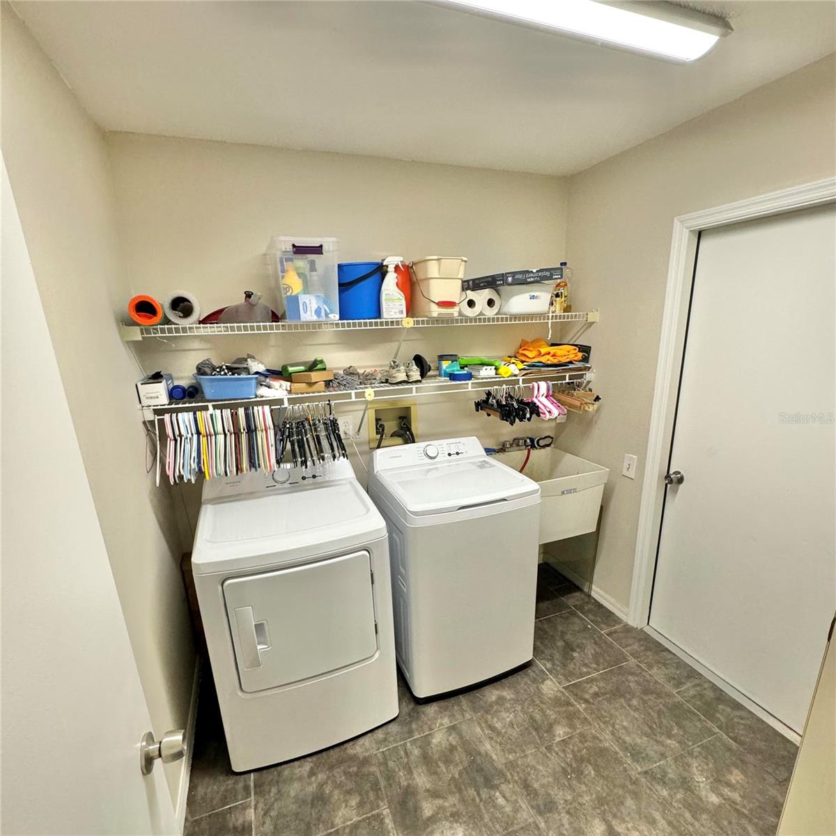 Inside laundry room with auxiliary sink