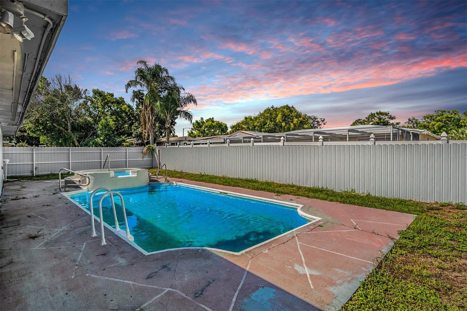 Fenced in back yard with pool/spa