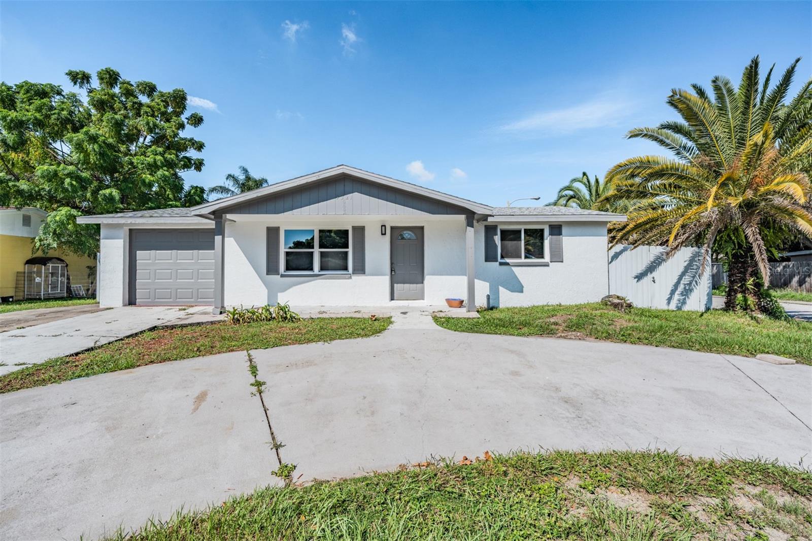 Overview of the home, circular driveway, minutes from the water.