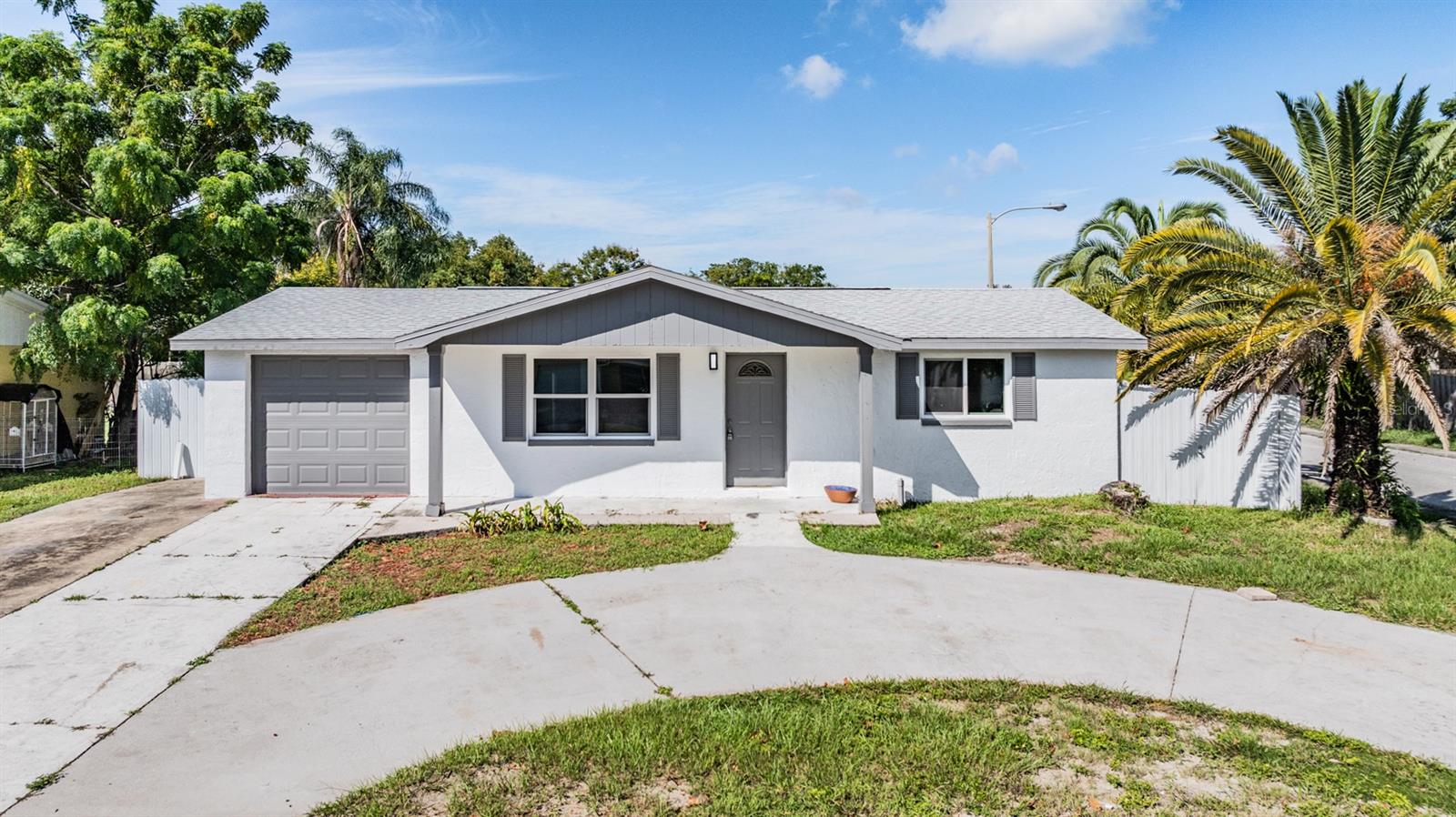 Front exterior of the home, circular driveway, minutes from the water.