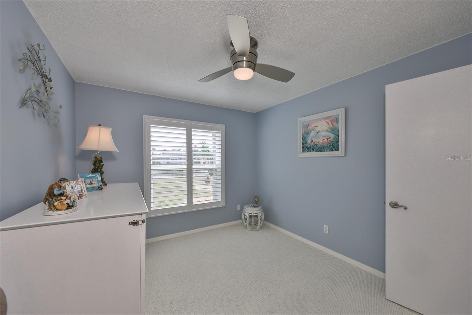 Freshly painted coastal colors make this room such a comfortable, relaxing space with a water view.  A Queen size murphy bed is to the left side of the picture and conveys with the home.