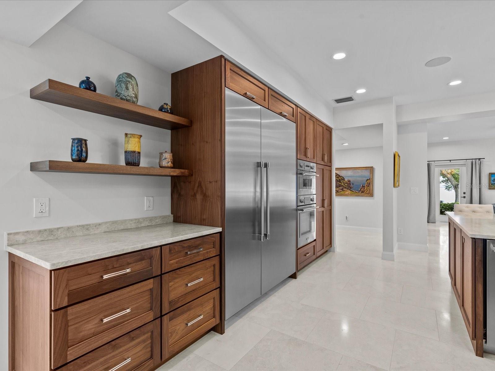 Custom walnut cabinetry with Taj Mahal quartz