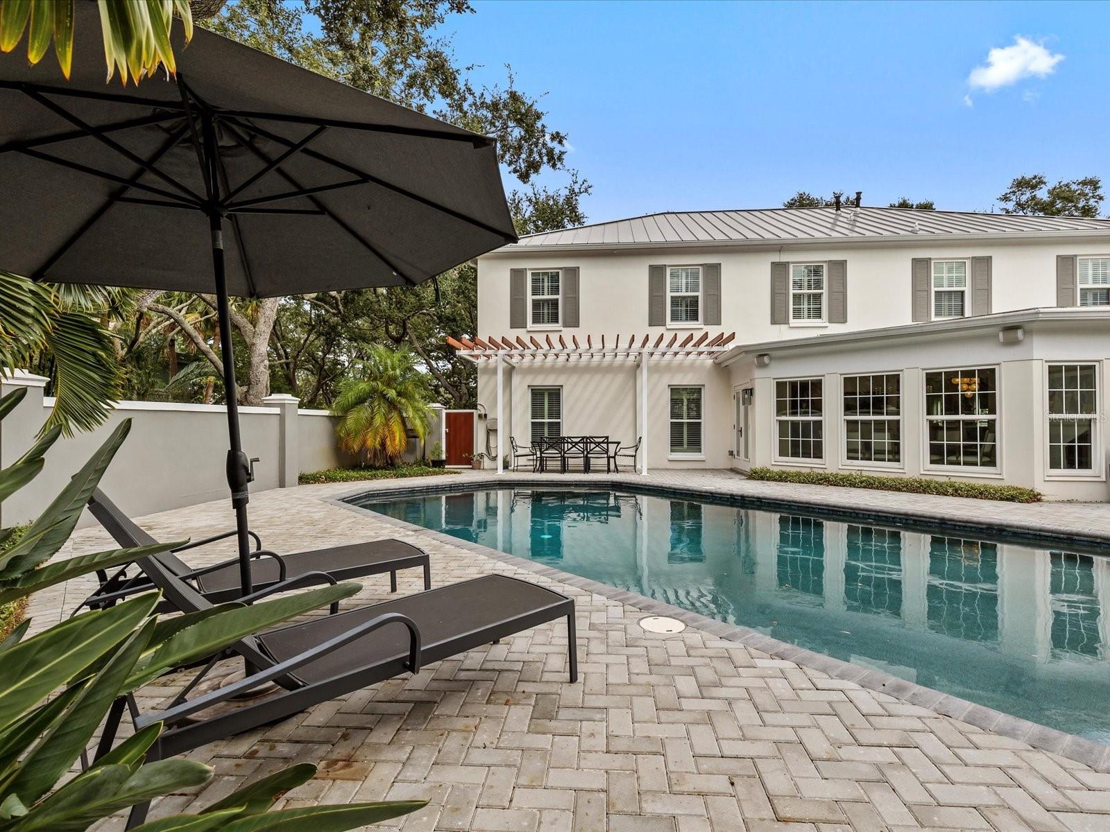 Oversized pool w/ private wall and dining area