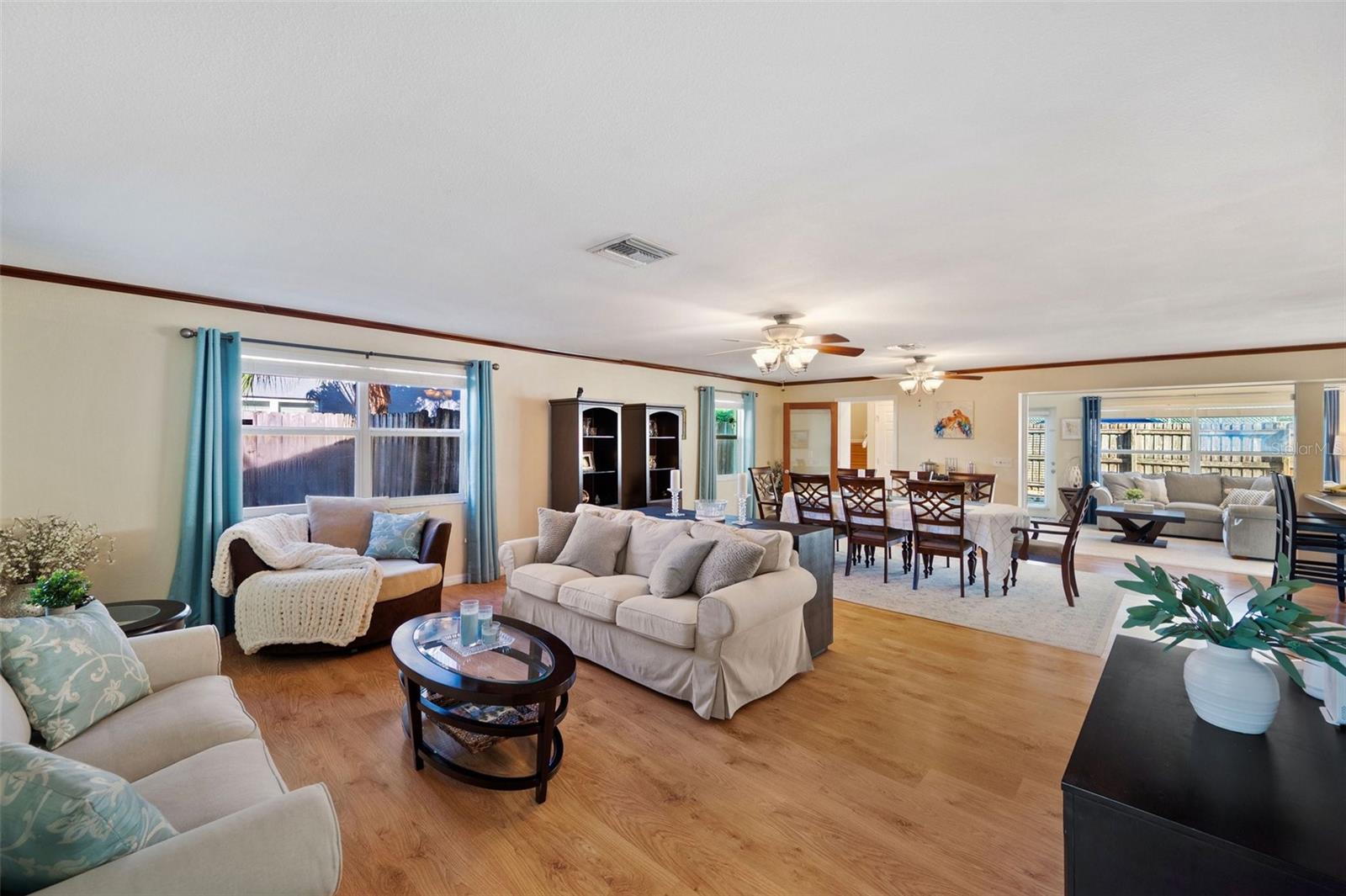 View as you step into Living Room from the front door: Dining room ahead, followed by a large Florida Room and a primary suite above.