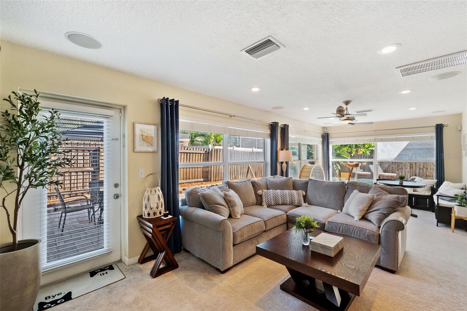 Oversized Florida Room with access to the fenced backyard with resort-style pool area!