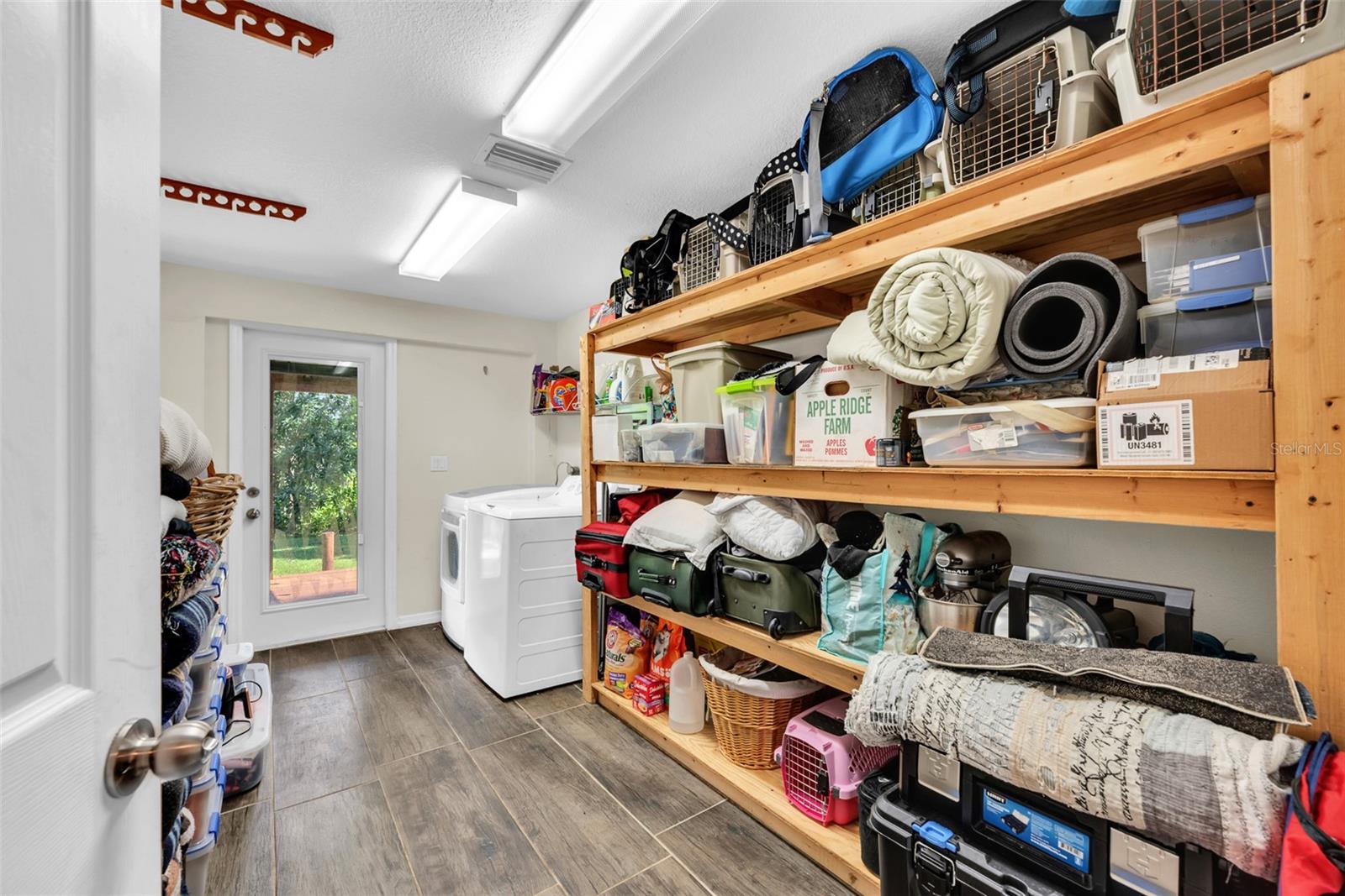 Inside Laundry with storage and access to backyard deck