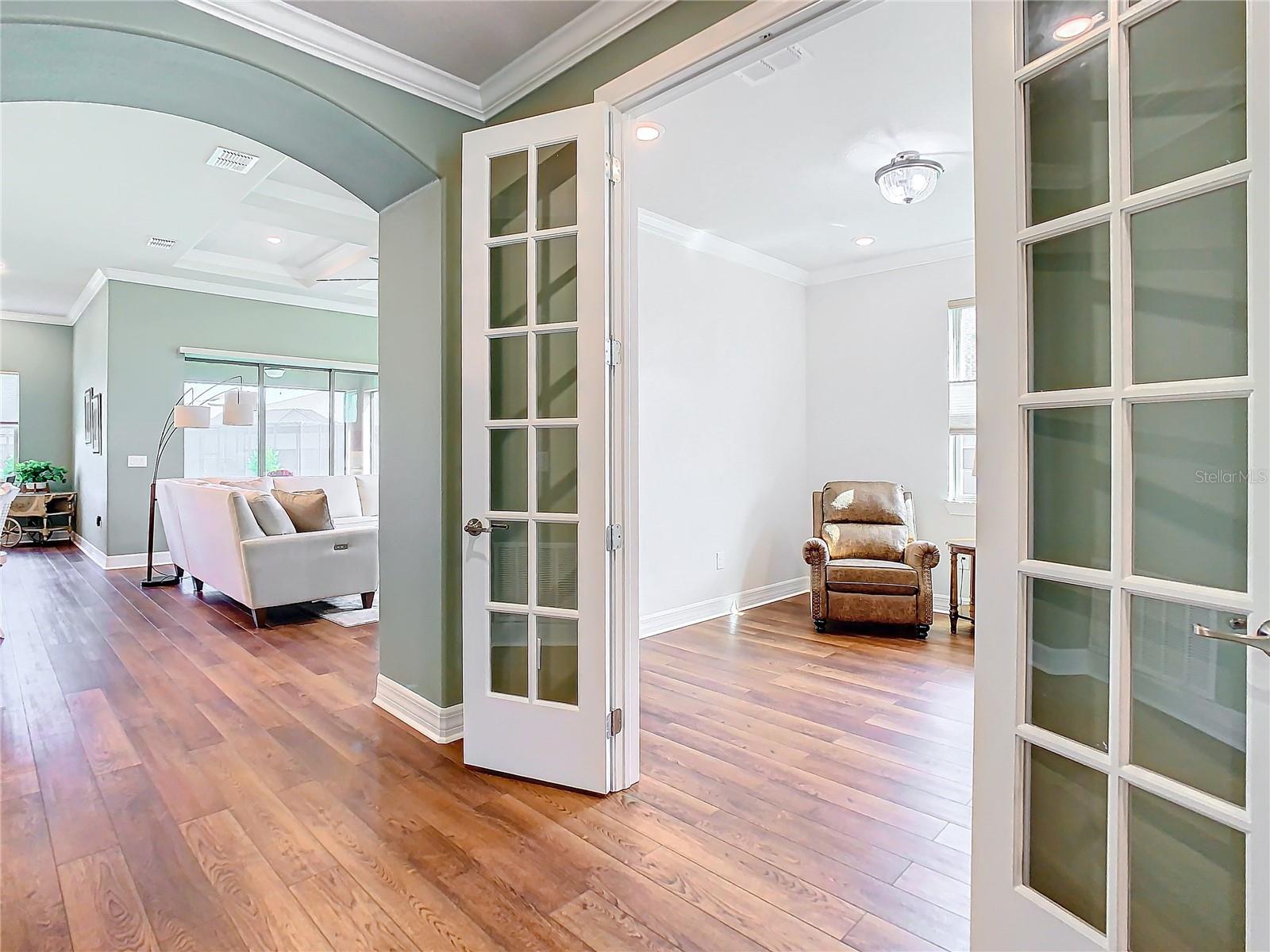 Pretty double French doors lead to the office/study.