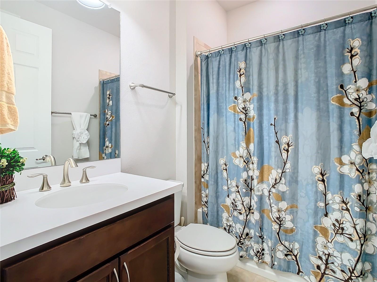 Secondary bathroom offers tub/shower.