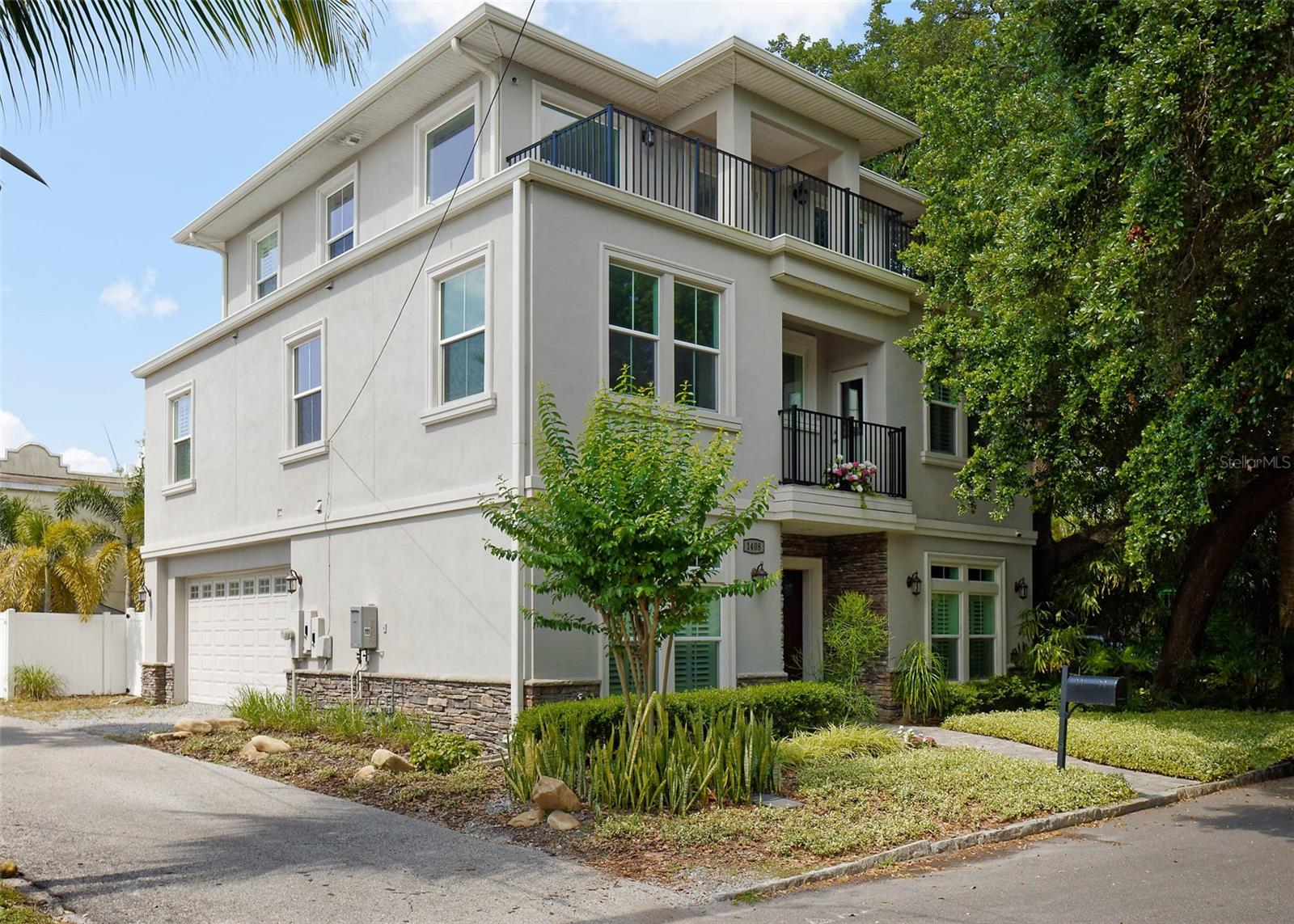 FRONT AND LEFT SIDE OF HOME SHOWING THE PRIMARY BEDROOM ON THE 3RD FLOOR AS WELL AS THE PARTY/VIEWING DECK