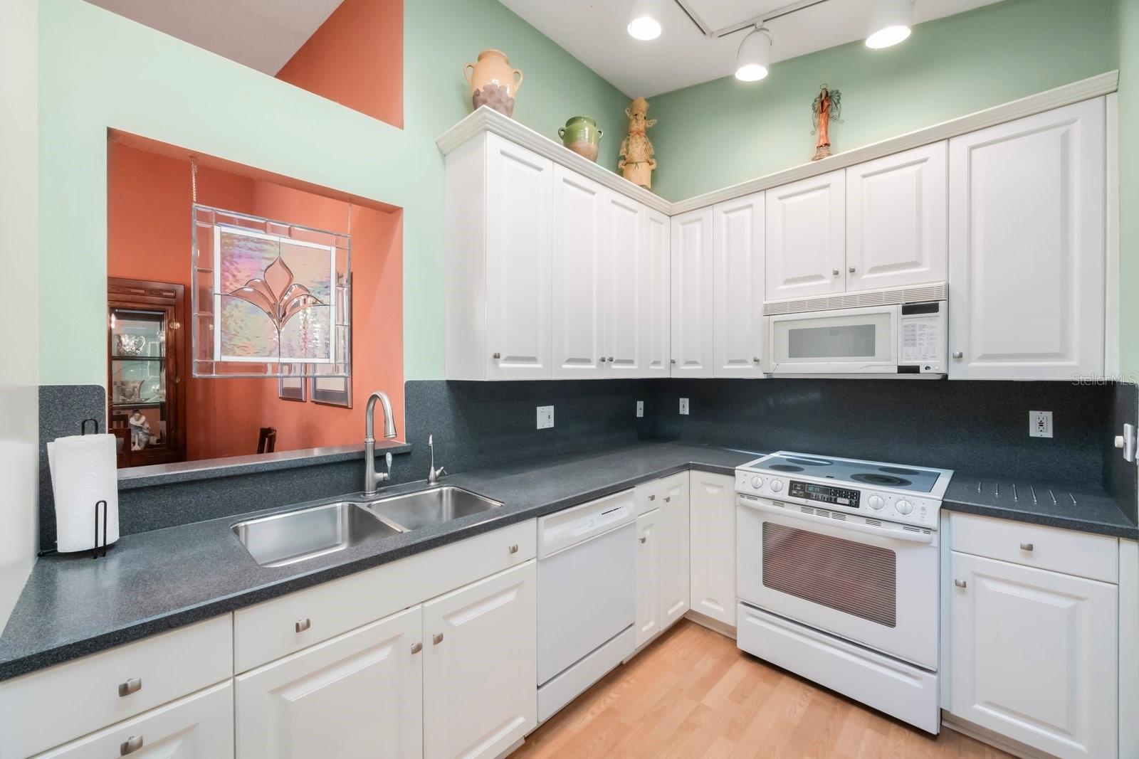 Spacious kitchen offers numerous cabinets and acres of counter space for gourmet prep