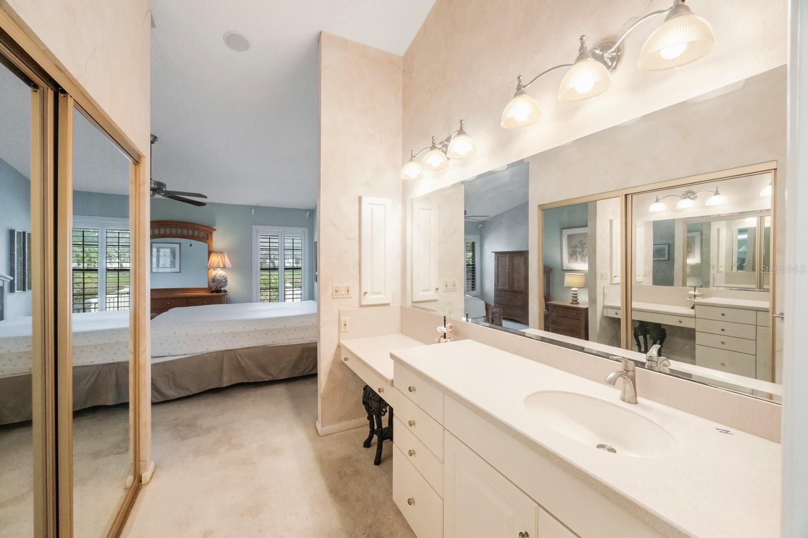 Dressing table and vanity separate from shower and toilet area.