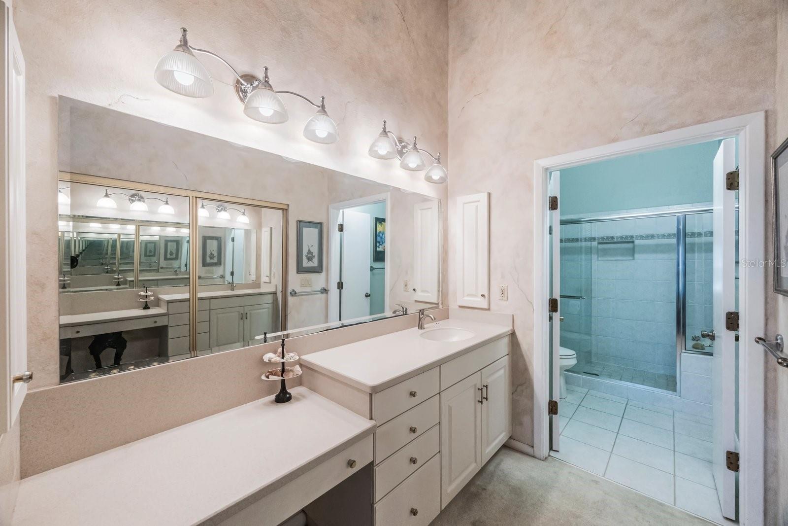 Well lit dressing area with vaulted ceilings