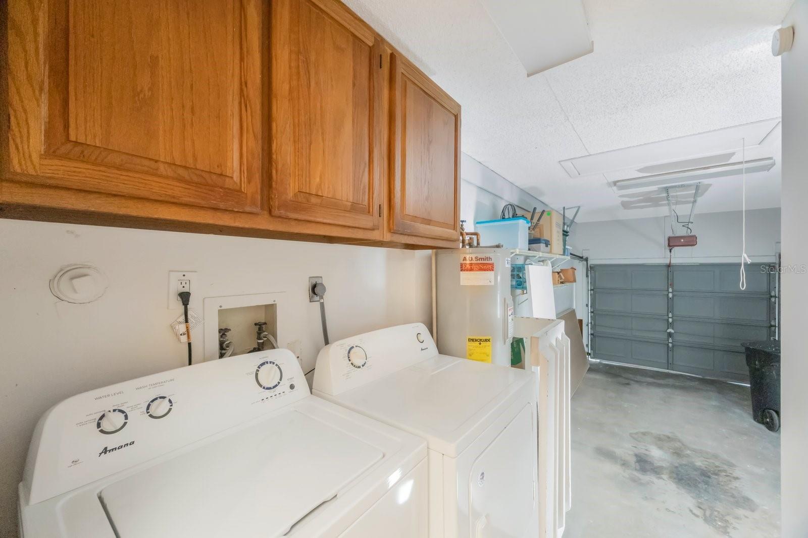 Washer and dryer convey and are located just outside the kitchen in garage entry.