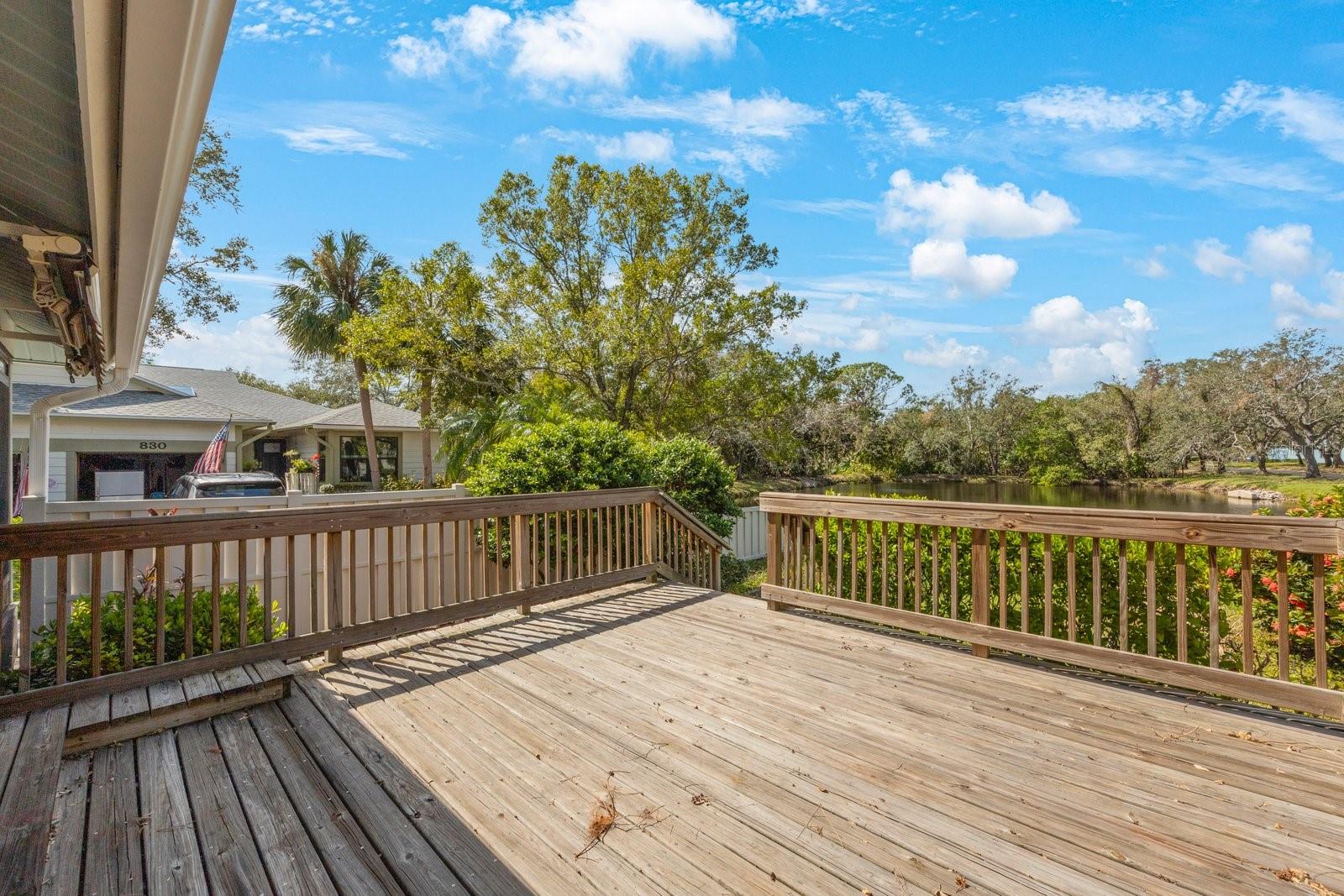 Back deck allows access to the backyard and lake