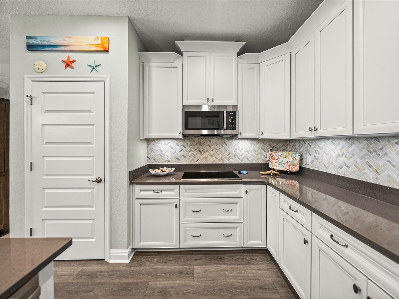 Kitchen with Staggered Built in 42" Uppers & Marble Backsplash