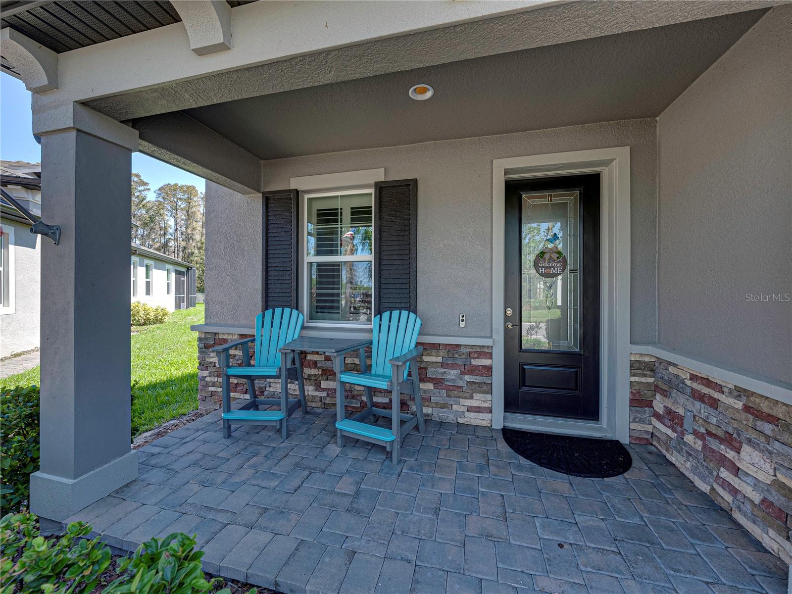 Covered Paver Front Porch with Stone Accents and Corbels