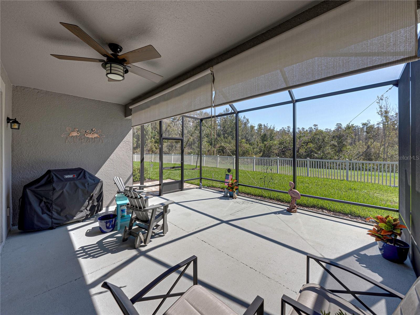 Rear Covered Screened Lanai with Roll Down Shades