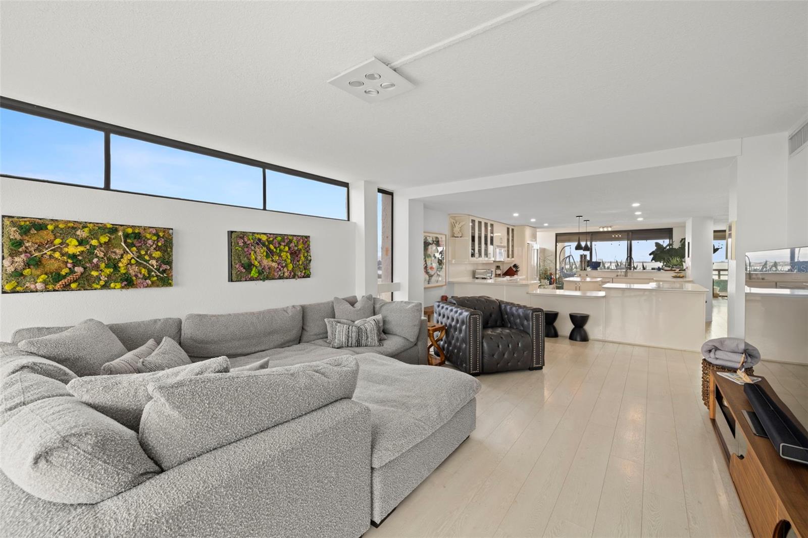 FAMILY ROOM WITH TRANSOM WINDOWS & PLANK LVP FLOORING