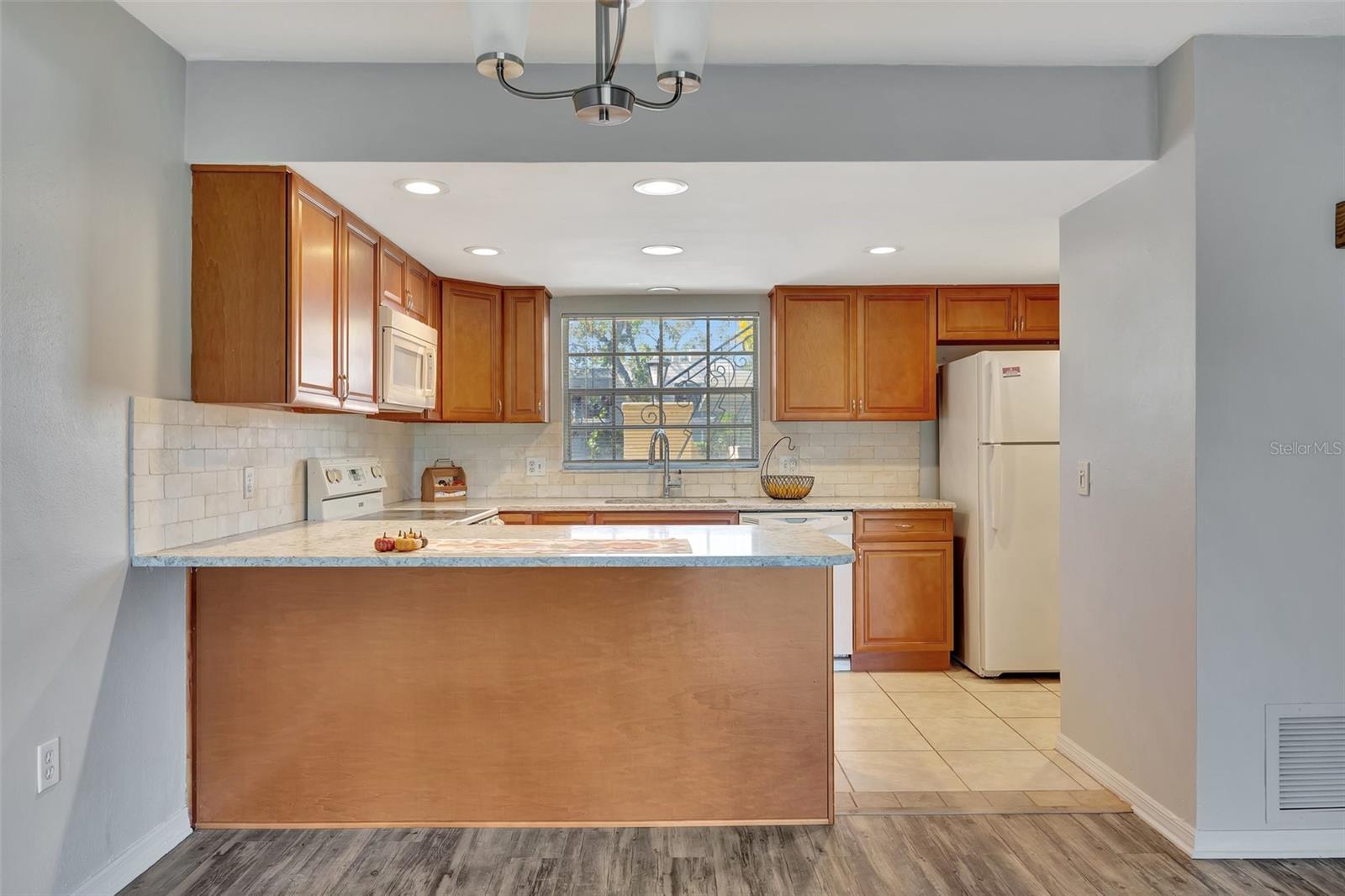 The kitchen is well appointed with beautiful granite countertops.