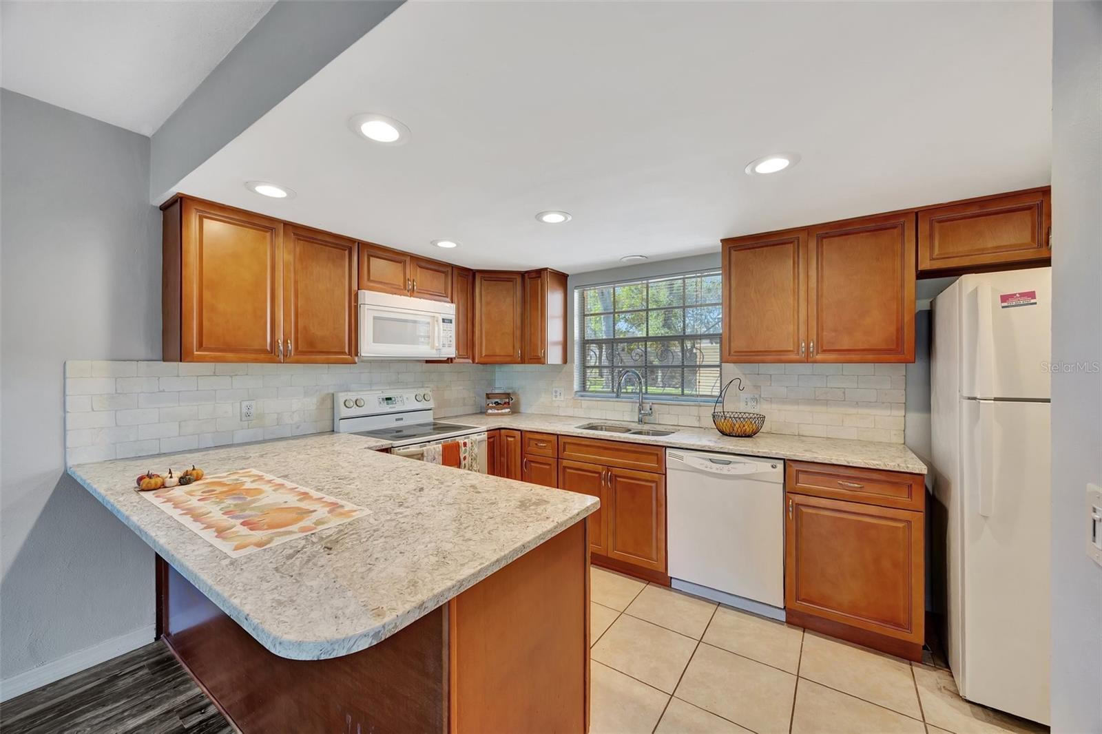 The kitchen is open and has plenty of natural light.