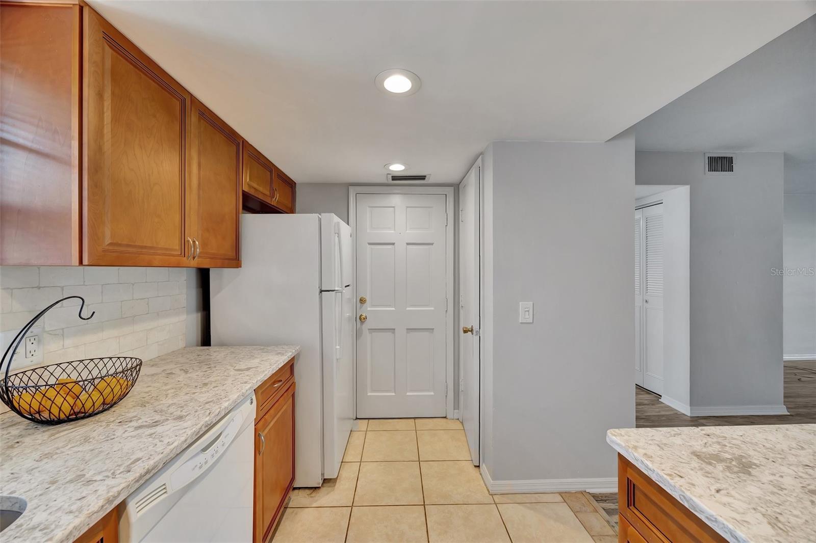 The kitchen has a pantry and a second exit out of the unit.