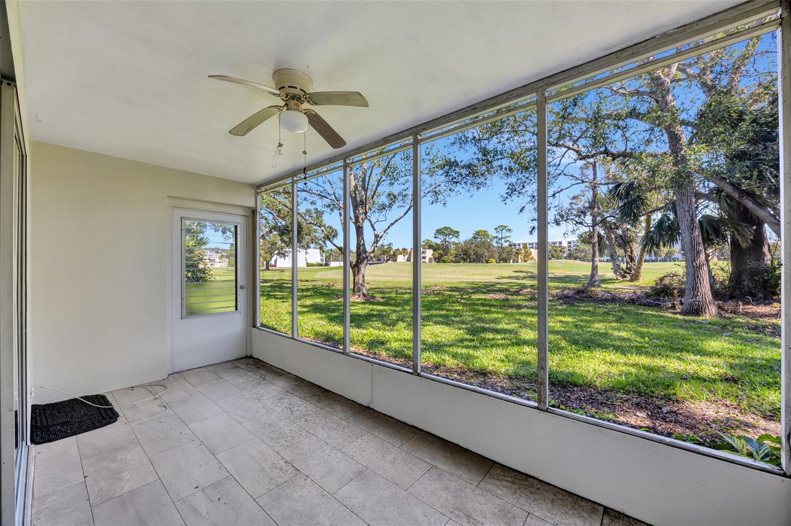 The exteriior screened porch is spacious and has a great view of the golf course