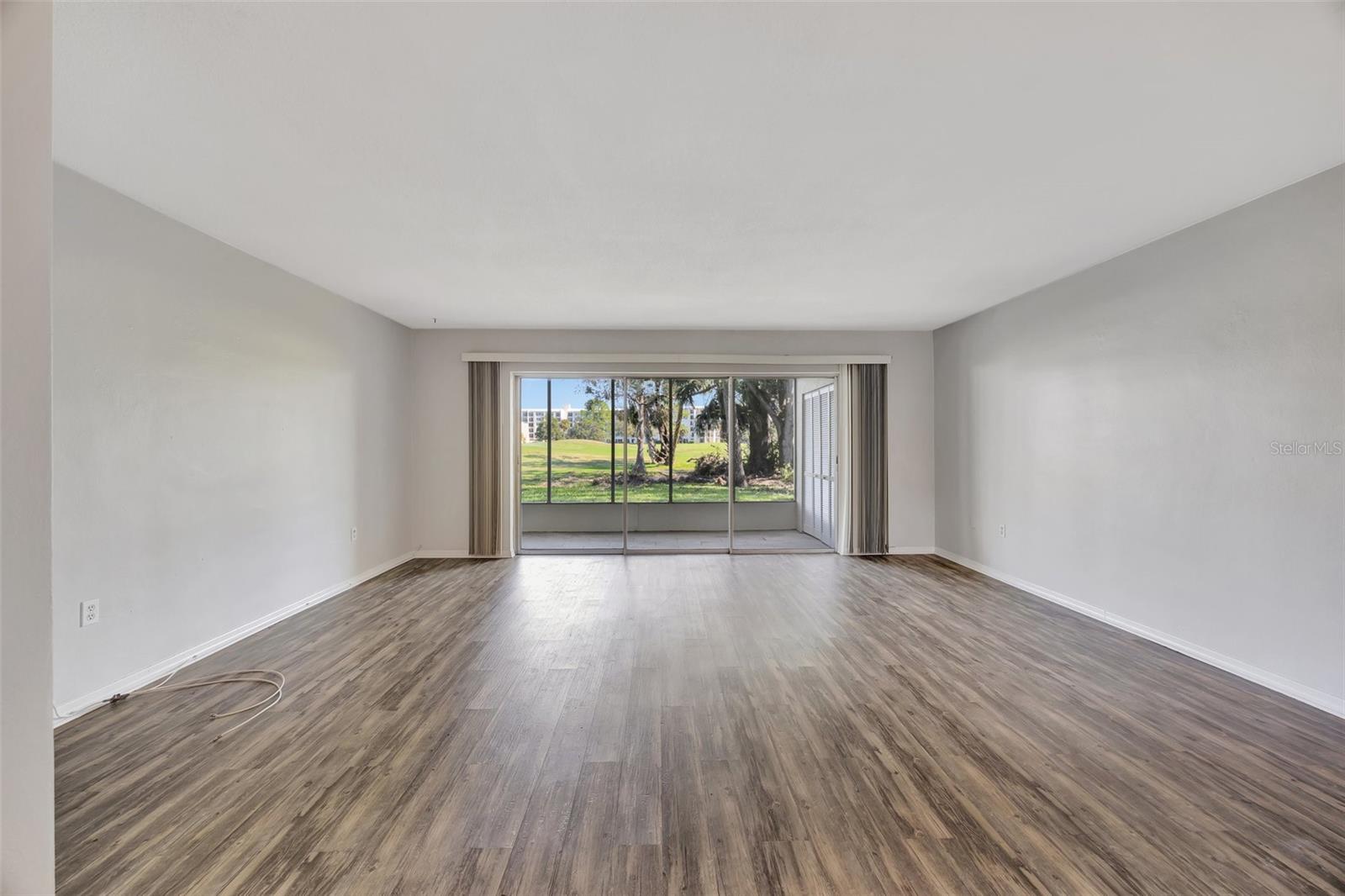 As you enter you see the large open living and dining space with a view of the golf course