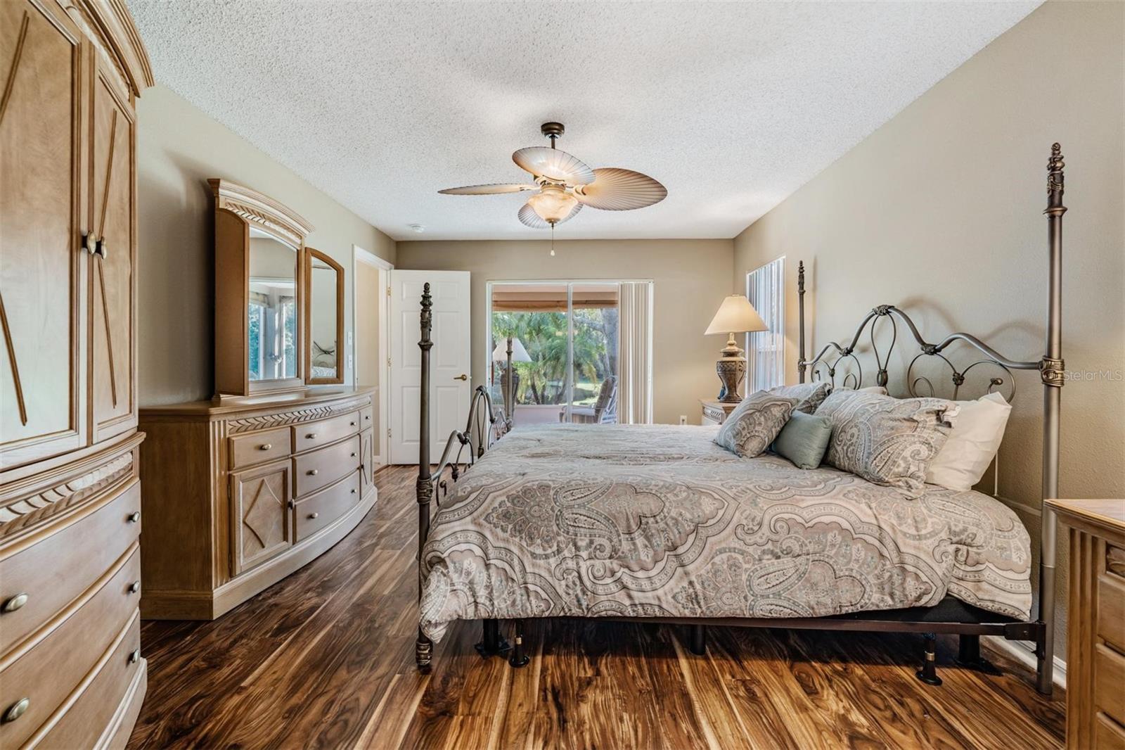 Master bedroom with a sliding glass door to the lanai