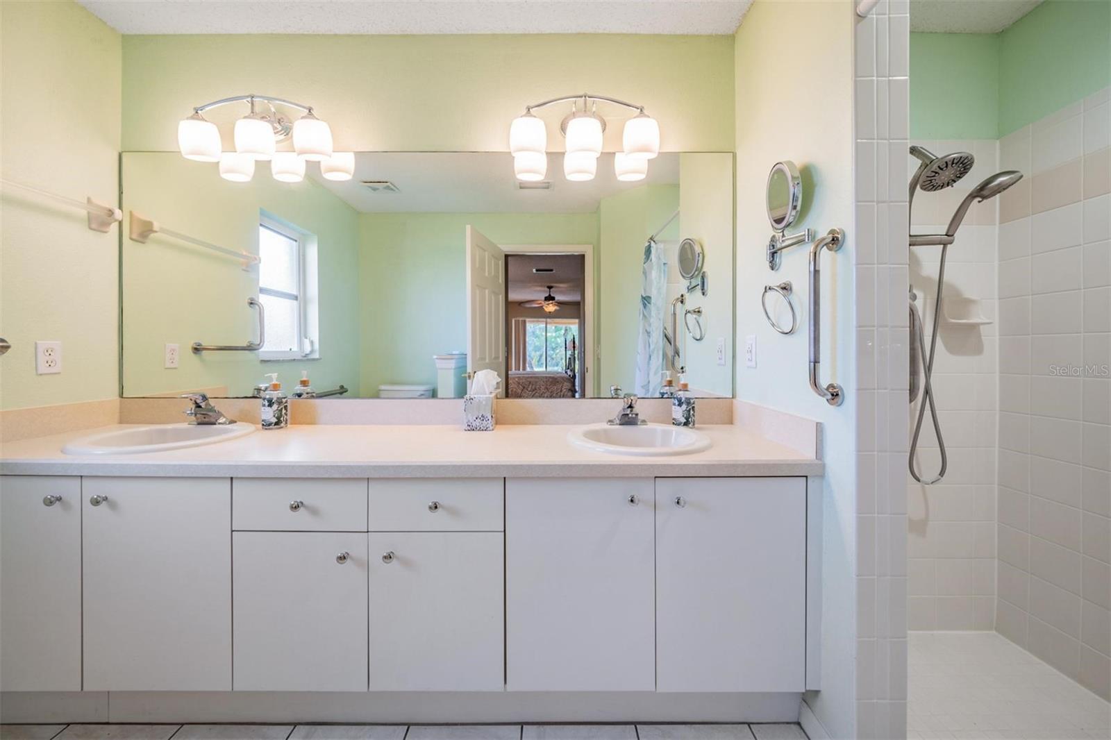 Step in shower; vanity provides additional storage options