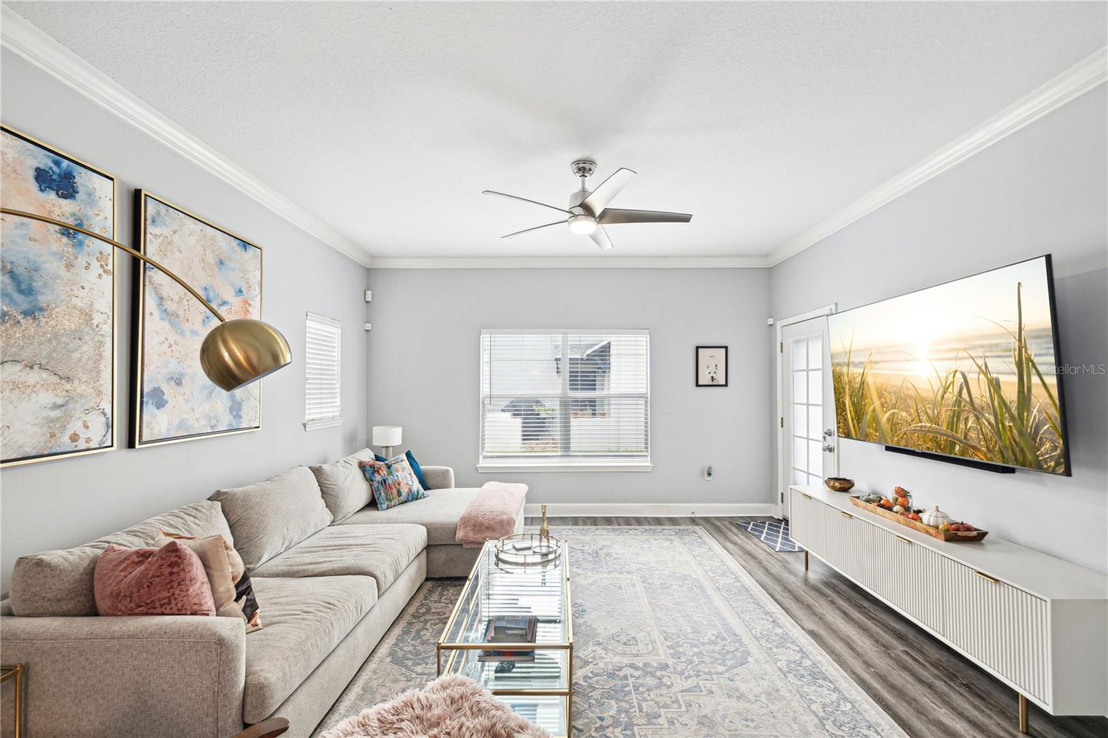 living room has tall ceilings and crown molding