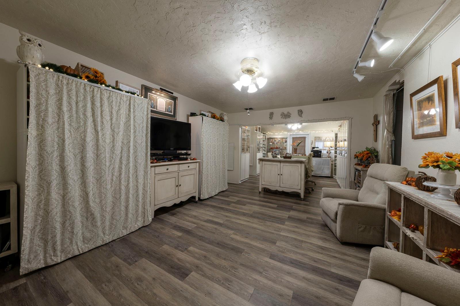 View from the entry showing the spacious livingroom with beautiful flooring.