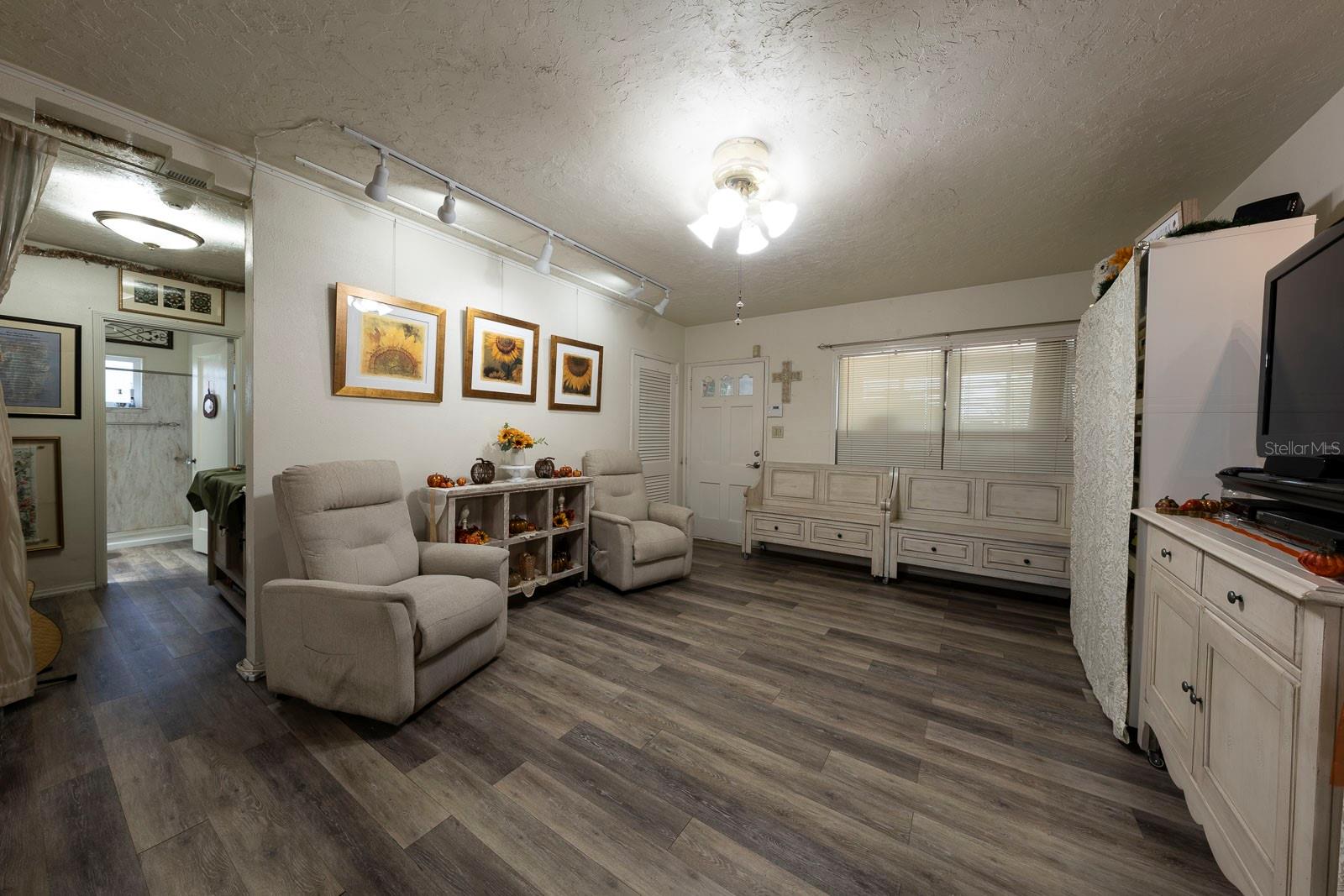 Another view looking towards the entry and showing the hallway to the bedrooms.