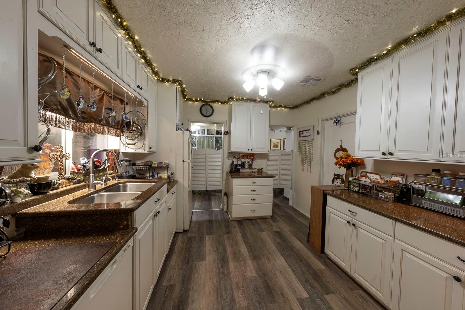 Lovely kitchen with lots of storage and counterspace. Beautiful countertops.