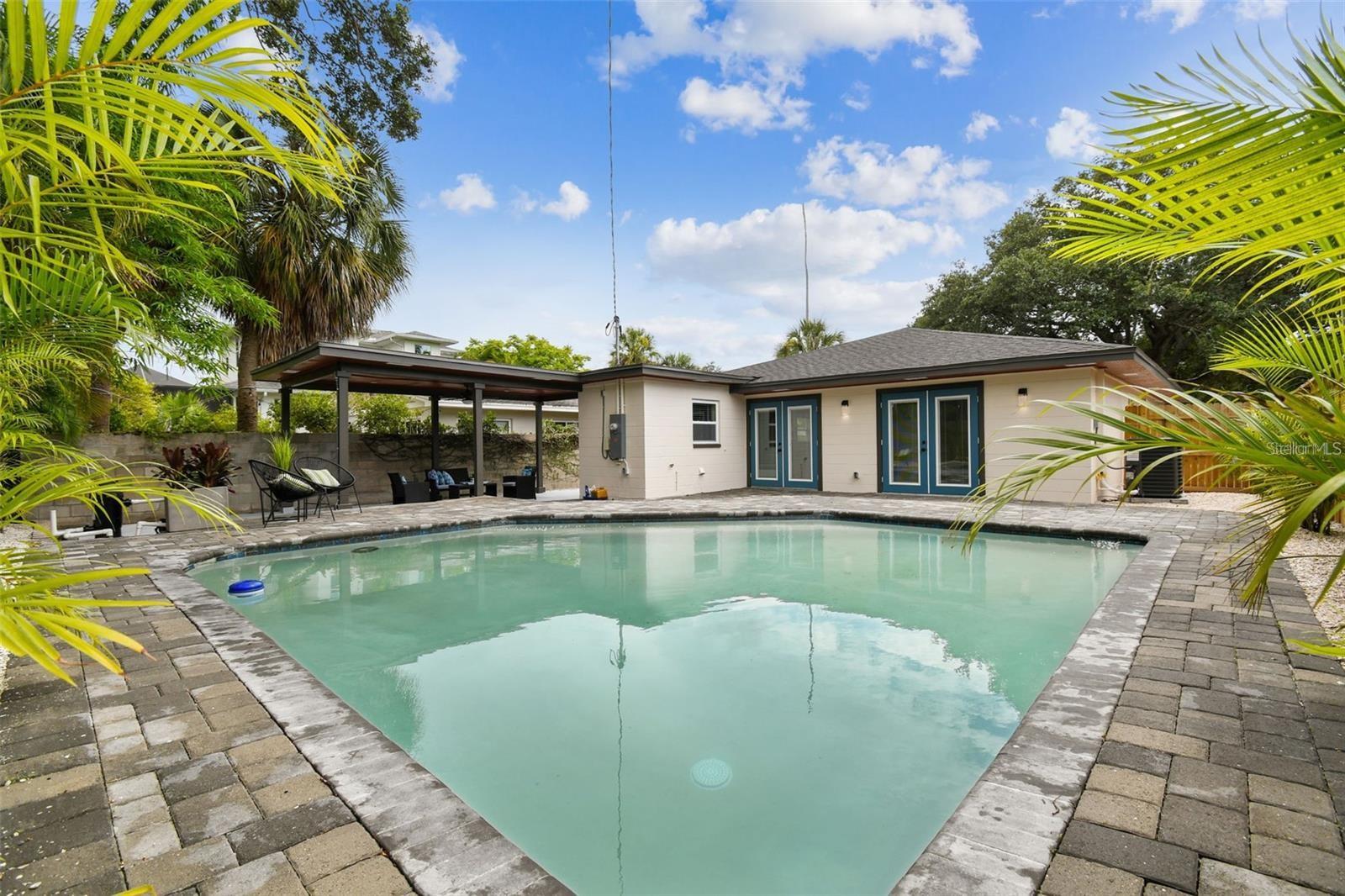 Previous image of the home from 2021. Pool with the back of the house shown.